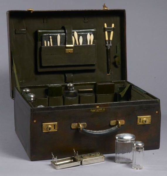 MAPPIN and WEBB, circa 1900-1920 Valise en cuir de Russie vert anglais chiffrée ML contenant un nécessaire de toilette: 6 flacons en cristal, bouchons en argent, boîte de rasage, manucure, coffret à bijoux, répertoire, carnet de croquis, fer à friser... g