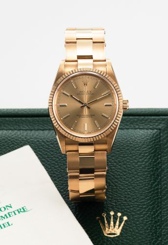 ROLEX REF. 14238 OYSTER PERPETUAL YELLOW GOLD.Rolex, Oyster Perpetual, Superlative Chronometer Officially.Certified, case NO. S631924, Ref. 14238. Made in 1993..Very fine, tonneau shaped, center seconds, self-winding, water.resistant, 18K yellow gold wris