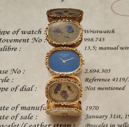 PATEK PHILIPPE REF. 4119 LADY'S YELLOW GOLD.Patek Philippe & Cie, Genève, No. 998743, case No. 2694305, Ref. 4119/1. Made in 1970..Very fine and unusual, 18K yellow gold lady's wristwatch with an 18K yellow gold bracelet formed by 9 oval.medallions Covere