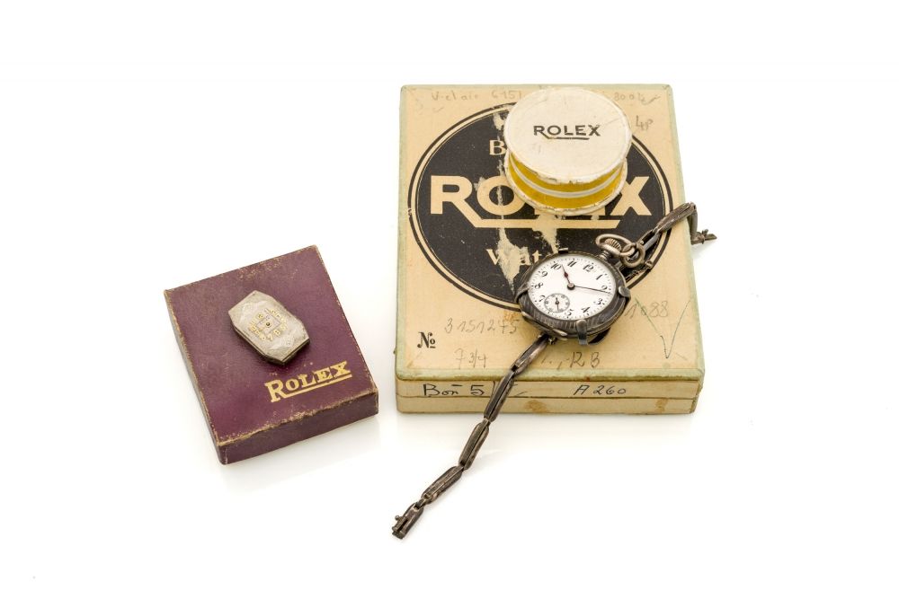WATCHMAKERS ROLEX BOX, ROLEX NIELLO POCKETWATCH AND HOLDER A watchmakers Rolex box containing a Rolex silver niello pocket watch, a silver spring-loaded pocket watch holder, a Rolex Prima movement and 2 Rolex boxes.