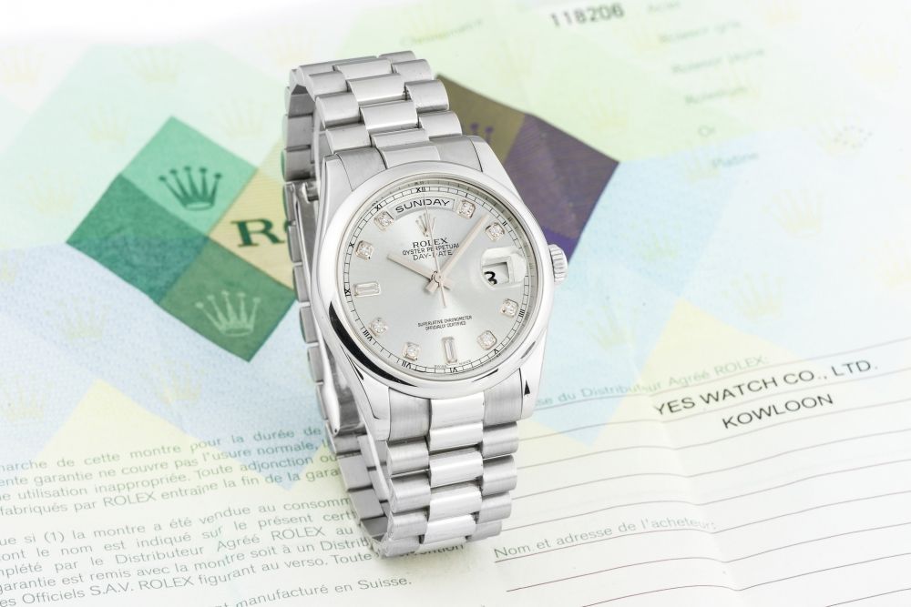 ROLEX, REF. 118206, DAY-DATE, PLATINUM A fine, heavy, self-winding, platinum day-date wristwatch with diamond indexes.