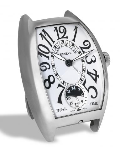 Franck Muller Desk Alarm.Clock _ Dual Time.Franck Muller, Geneve, Desk Alarm.Clock, Dual Time, No. 00370..Made circa 2005..Fine and rare, tonneau-shaped, two time.zone, stainless steel quartz alarm desk.clock. Accompanied by the original fitted.box and Ce