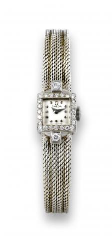 Omega White Gold & Diamonds.Omega, movement No. 12384537, case No. 10816168..Made in the 1950s..Fine and elegant, diamond-set 18K white gold lady's.wristwatch with an 18K white gold integral bracelet..To be sold without reserve