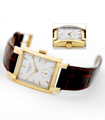 Patek Philippe Ref. 2427 Yellow Gold.Patek Philippe & Cie, Geneve, No. 973571, case No. 512699, Ref. 2427. Made circa.1951..Fine and rare, large, rectangular curved, 18K yellow gold wristwatch with an.18K yellow gold Patek Philippe buckle.