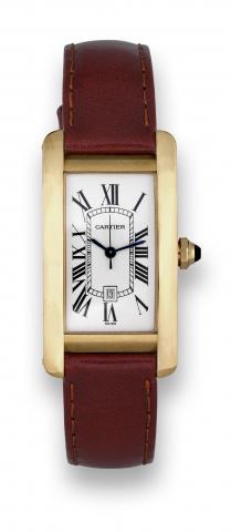 Cartier Tank Americaine.Cartier, Tank Americaine, Automatic.case No. 269982 CD, Ref. 2483. Made in.the 1990s..Fine, rectangular curved, center seconds.self-winding, water-resistant, 18K yellow.gold wristwatch with date and an 18K.yellow gold Cartier buckl