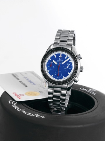 Racing.Omega, Speedmaster, Automatic, case No. 56307657.Ref. 351081. Sold on August 30th, 1999..Fine, asymmetric, self-winding, water-resistant, stainless.steel wristwatch with round button chronograph, registers.tachometer and a stainless steel Omega bra