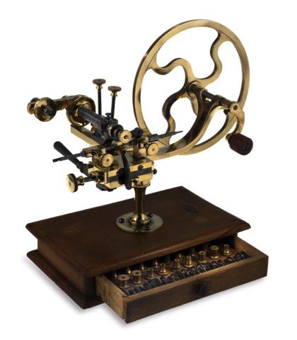 ROUNDING-UP TOOL.Sandoz Fils & Co., La Chaux-de-Fonds & Bienne, Swiss. Made.circa 1910..Fine, brass and steel rounding-up tool on wooden base with.drawer containing a selection of cutting wheels..To be sold without reserve
