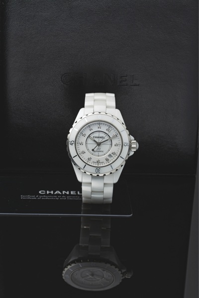 CHANEL J12 STEEL WHITE CERAMIC & DIAMOND.Chanel, Paris, J12 Automatic 200M, Ref. J.M. 96478. Made.circa 2005..Very fine, curved, center seconds, self-winding, waterresistant.stainless steel, ceramic and diamonds.wristwatch with date and a white