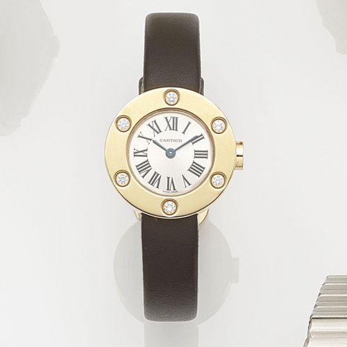 Cartier. A lady's 18ct gold and diamond set quartz wristwatch
