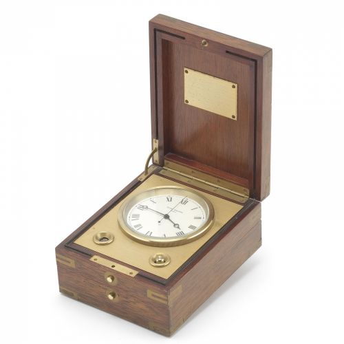 Patek Philippe. A brass and mahogany cased quartz desk clock