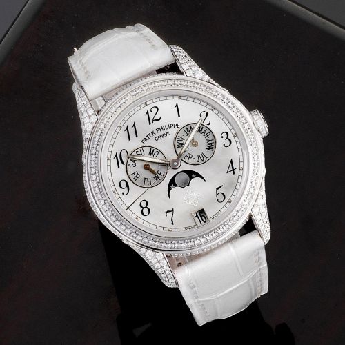Patek Philippe. A very fine 18K white gold and diamond set automatic annual calendar wristwatch with moon phase