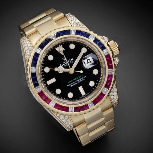 Rolex. A fine 18K gold, diamond, ruby and sapphire set automatic calendar bracelet watch with dual time zone