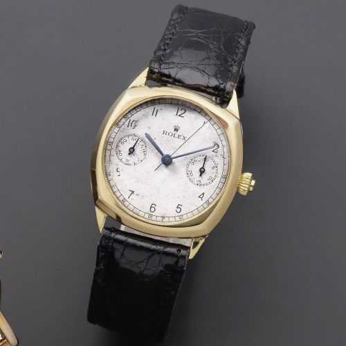 Rolex. An 18K gold manual wind single button chronograph cushion form wristwatch