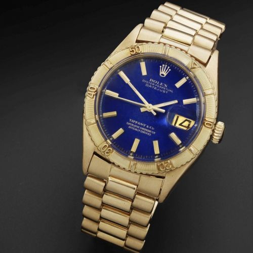 Rolex. An 18K gold automatic calendar bracelet watch retailed by Tiffany & Co