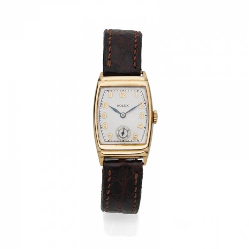 Rolex. A 9K gold manual wind tonneau form wristwatch