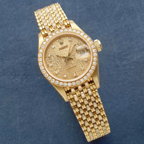 Rolex. A lady's 18K gold and diamond set automatic calendar bracelet watch