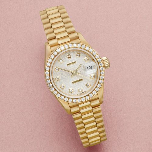Rolex. A lady's 18K gold and diamond set automatic calendar bracelet watch