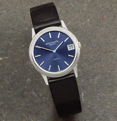 Patek Philippe. An 18K white gold automatic calendar wristwatch retailed by Gübelin