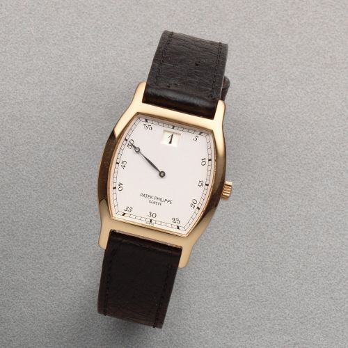 Patek Philippe. An 18K rose gold manual wind jump hour tonneau form wristwatch