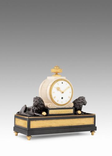 An early 19th century gilt and patinated bronze mounted marble and slate mantel timepiece