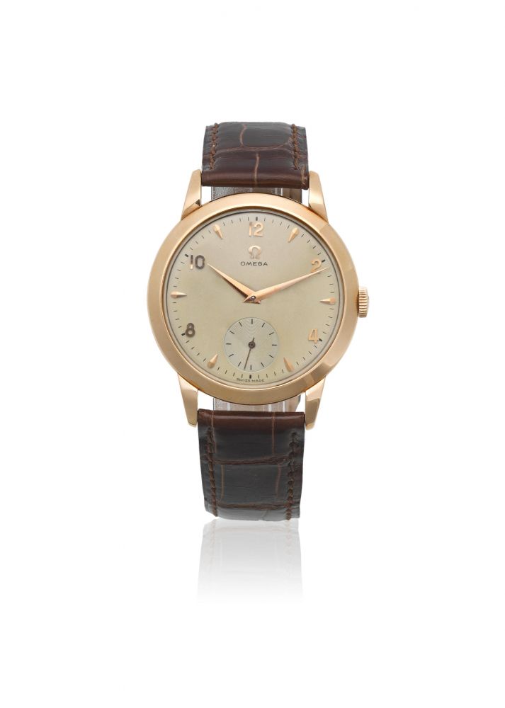 Omega. An 18K gold manual wind wristwatch