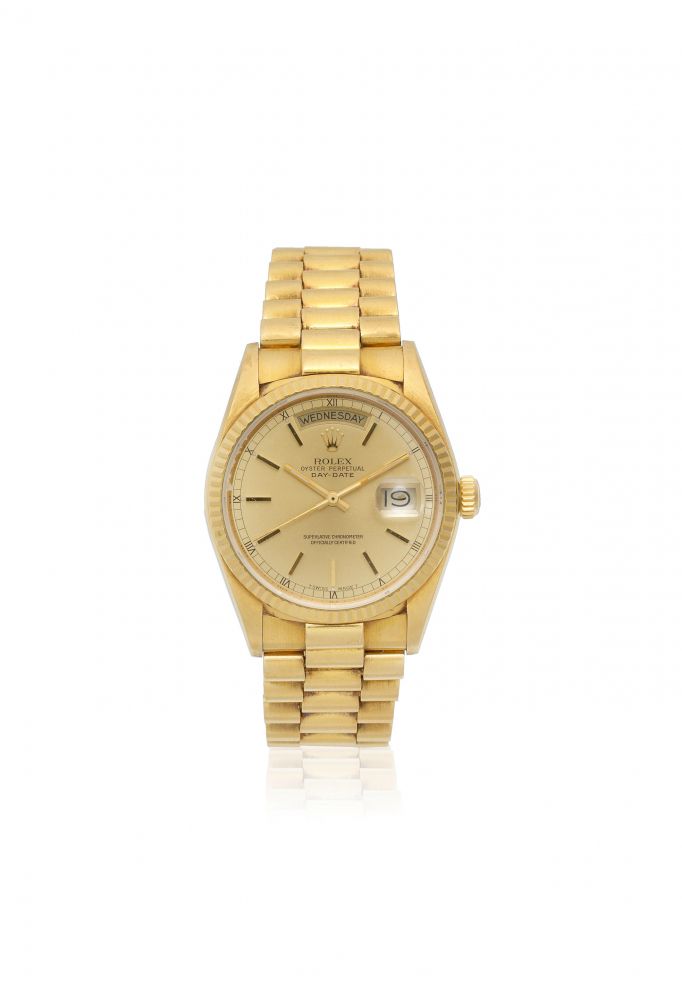 Rolex. An 18K gold automatic calendar bracelet watch