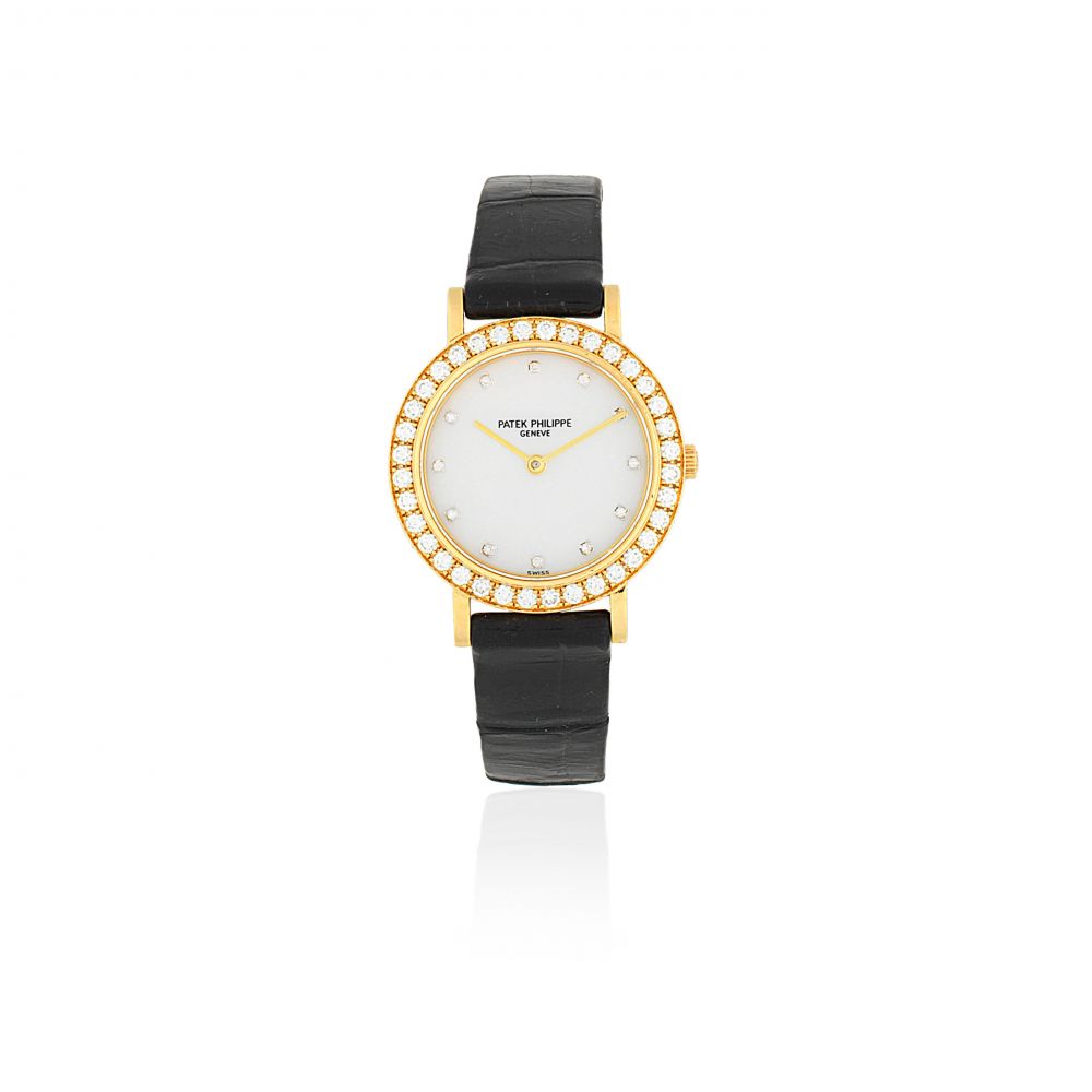 Patek Philippe. A lady's 18k gold and diamond set quartz wristwatch with mother of pearl dial