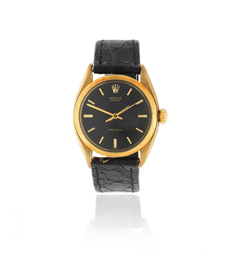 Rolex. A 9K gold manual wind wristwatch