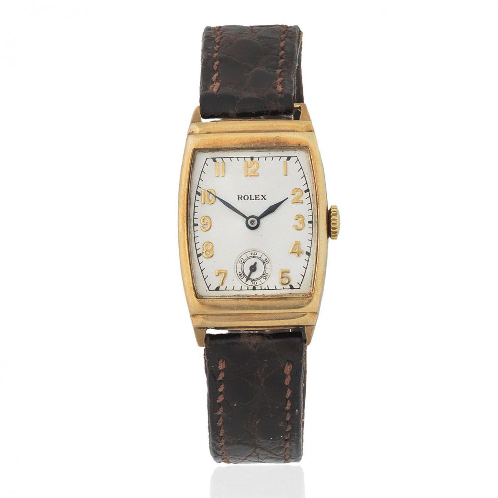 Rolex. A 9K gold manual wind tonneau form wristwatch
