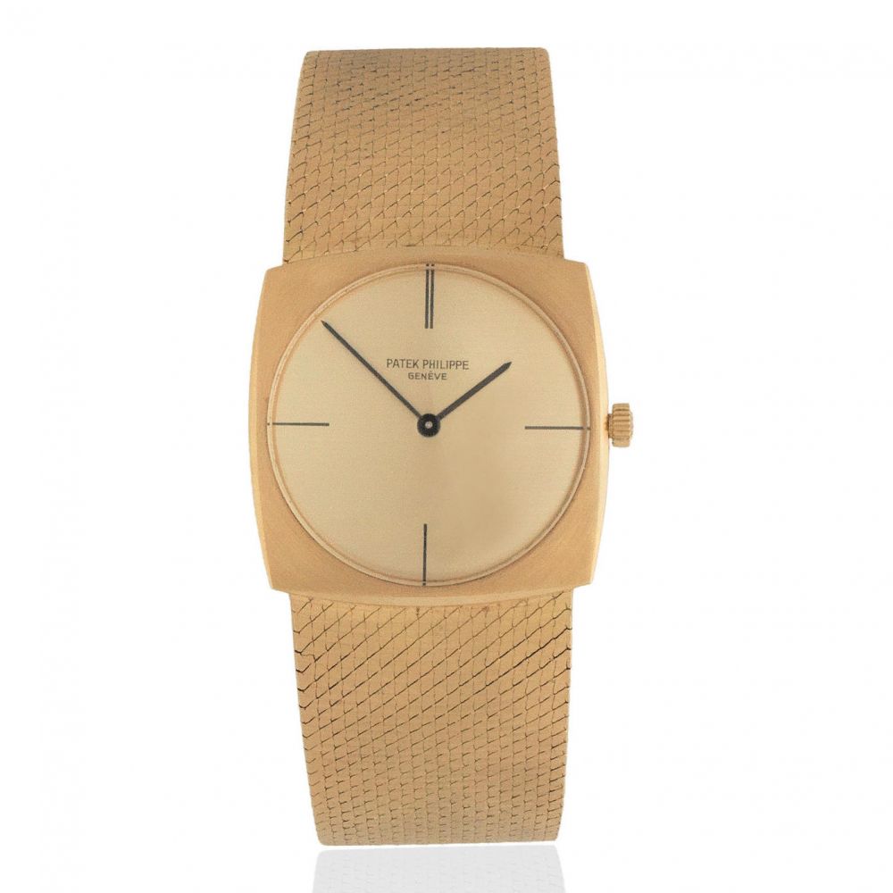 Patek Philippe. An 18K gold manual wind cushion form bracelet watch