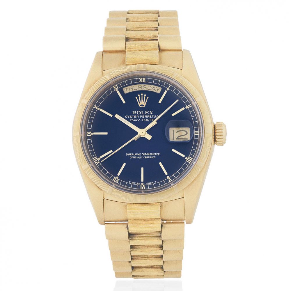 Rolex. An 18K gold automatic calendar bracelet watch