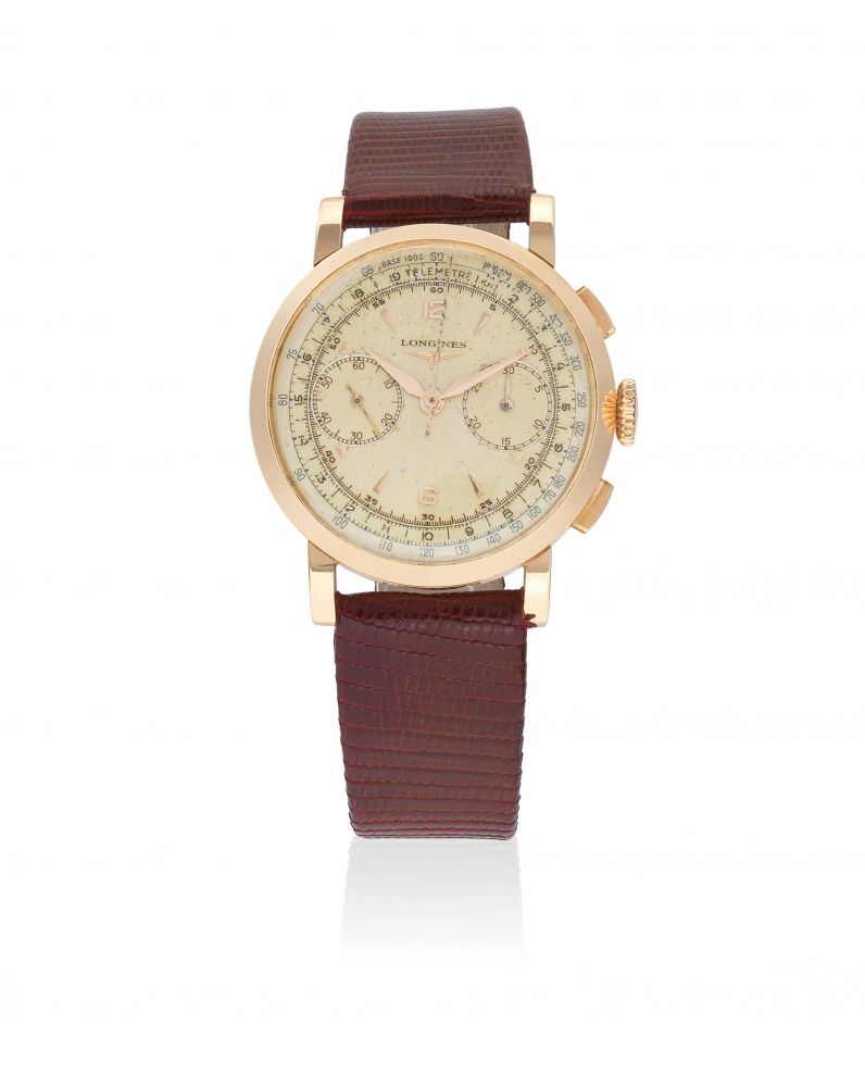 Longines. An 18K gold manual wind flyback chronograph wristwatch