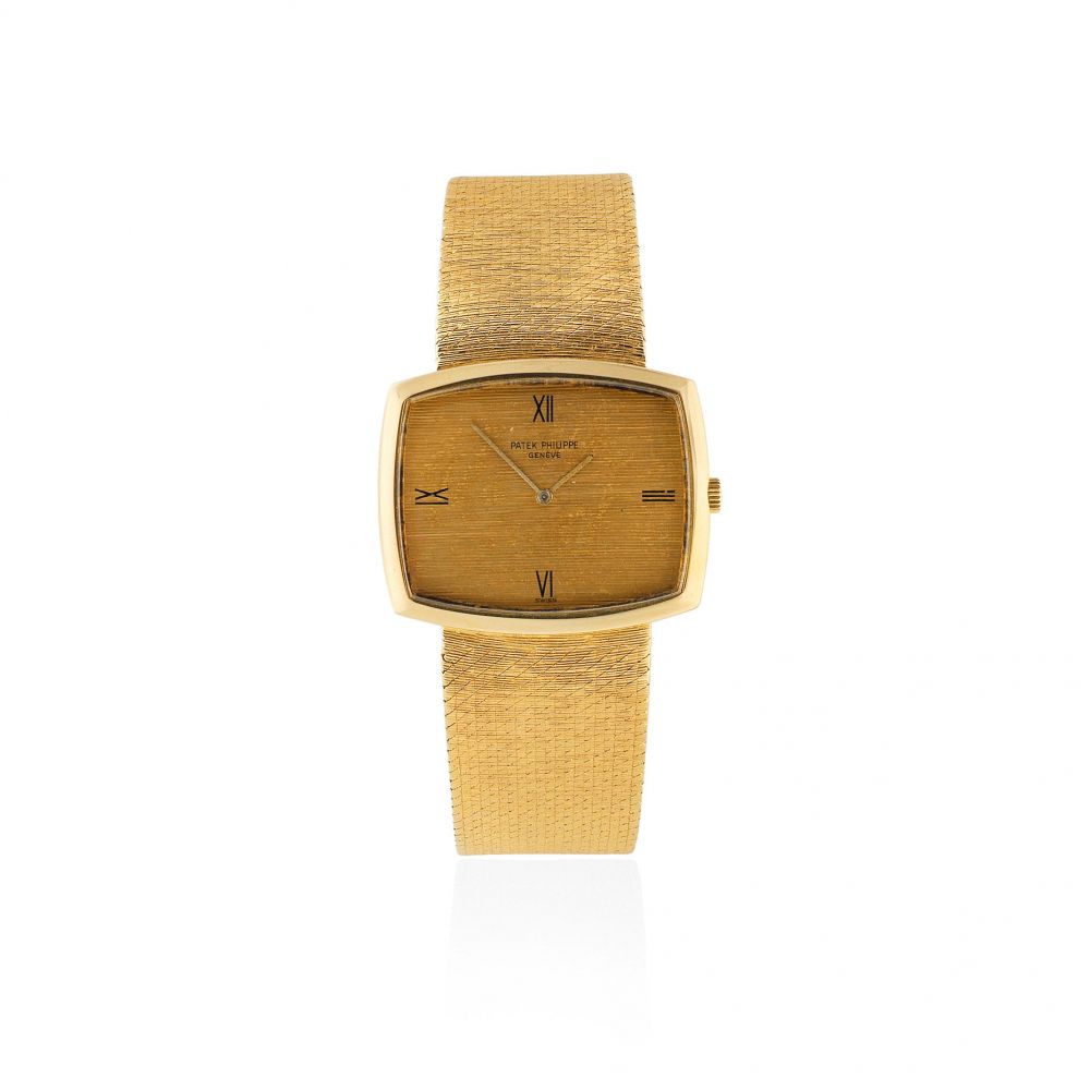 Patek Philippe. An 18K gold manual wind cushion form bracelet watch