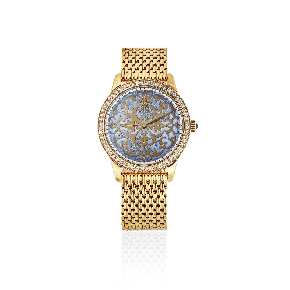 William & Son. An unusual 18K gold and diamond set automatic bracelet watch with Khanjar emblem and enamel dial