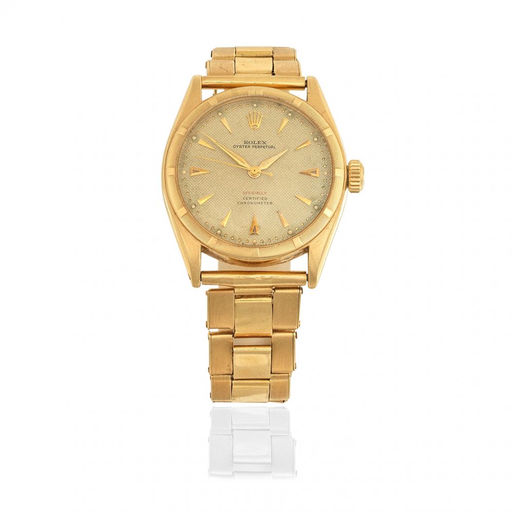 Rolex. An 18K gold automatic bracelet watch with original papers