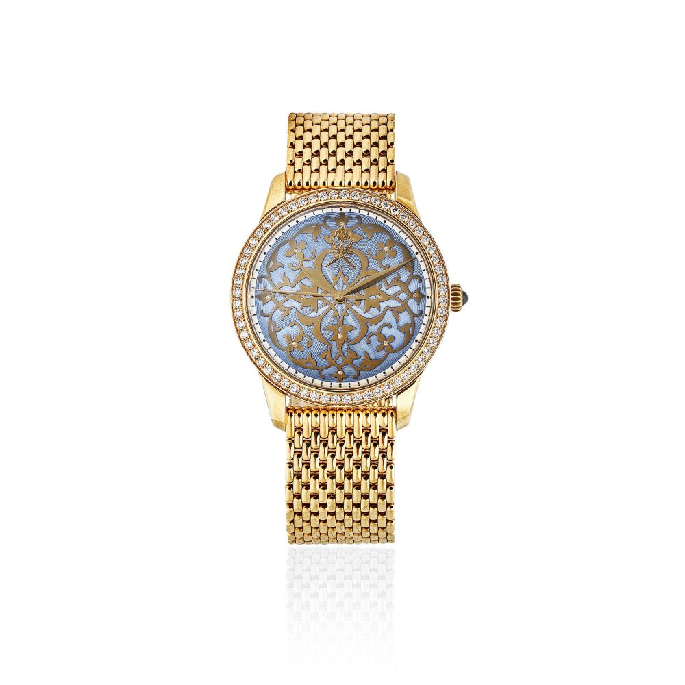 William & Son. An unusual 18K gold and diamond set automatic bracelet watch with Khanjar emblem and enamel dial