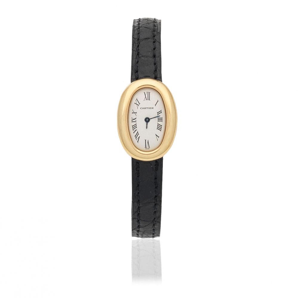 Cartier. A lady's 18K gold quartz oval wristwatch