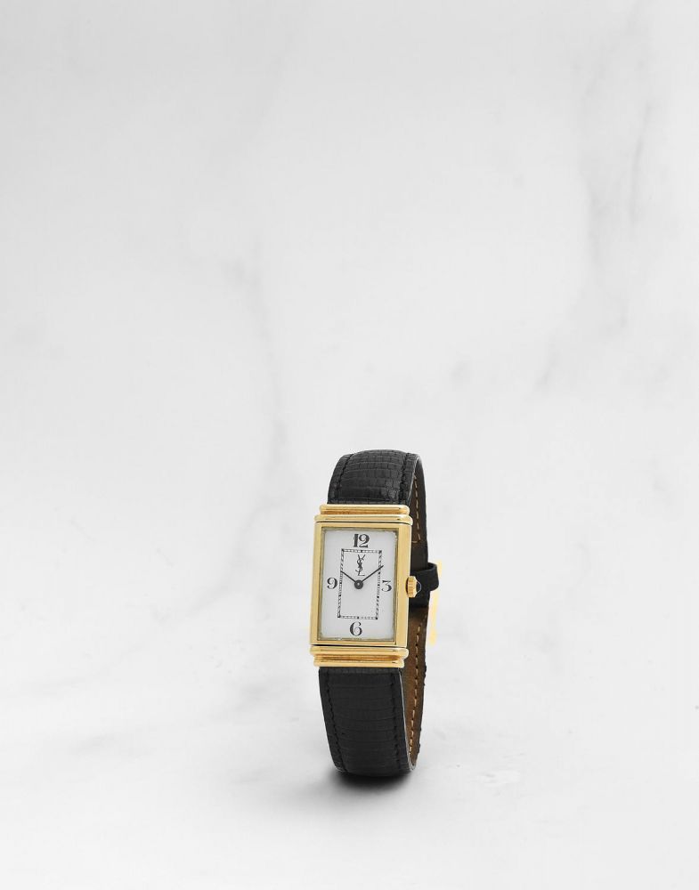 Yves Saint Laurent. Montre bracelet en or jaune 18K (750) rectangulaire réversible mouvement mécanique