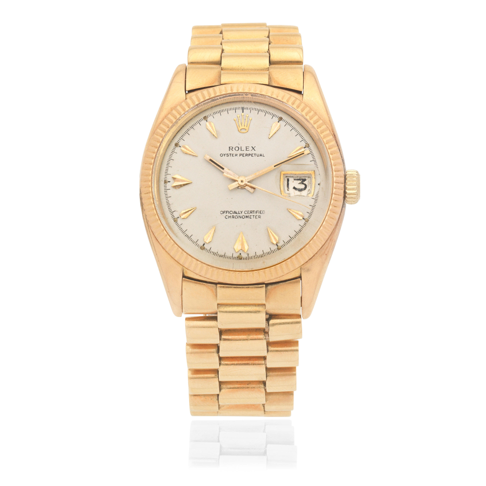 Rolex. An 18K gold automatic calendar bracelet watch