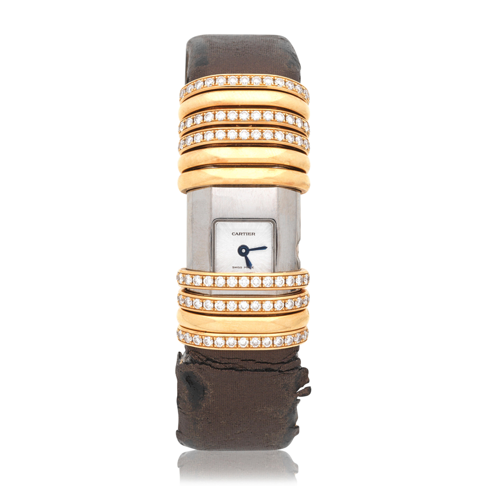 Cartier. A lady's gold and titanium diamond set quartz wristwatch