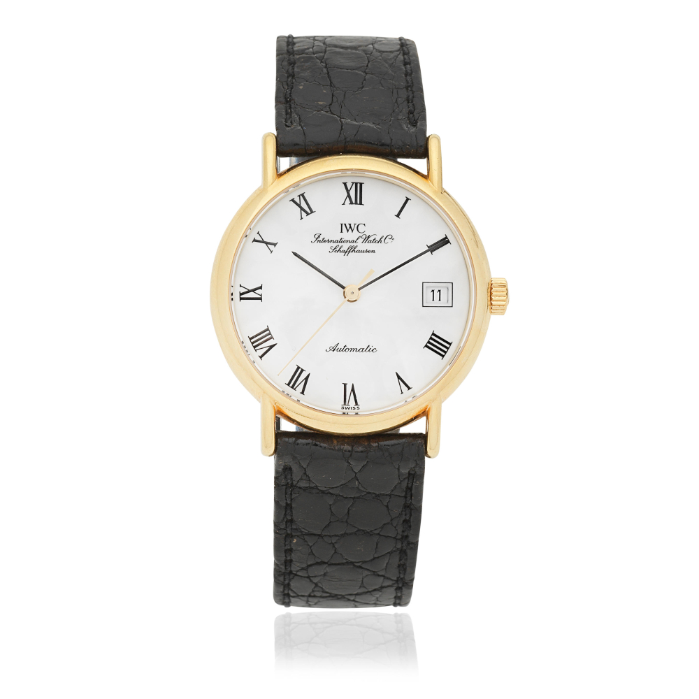 IWC. An 18K gold automatic calendar wristwatch