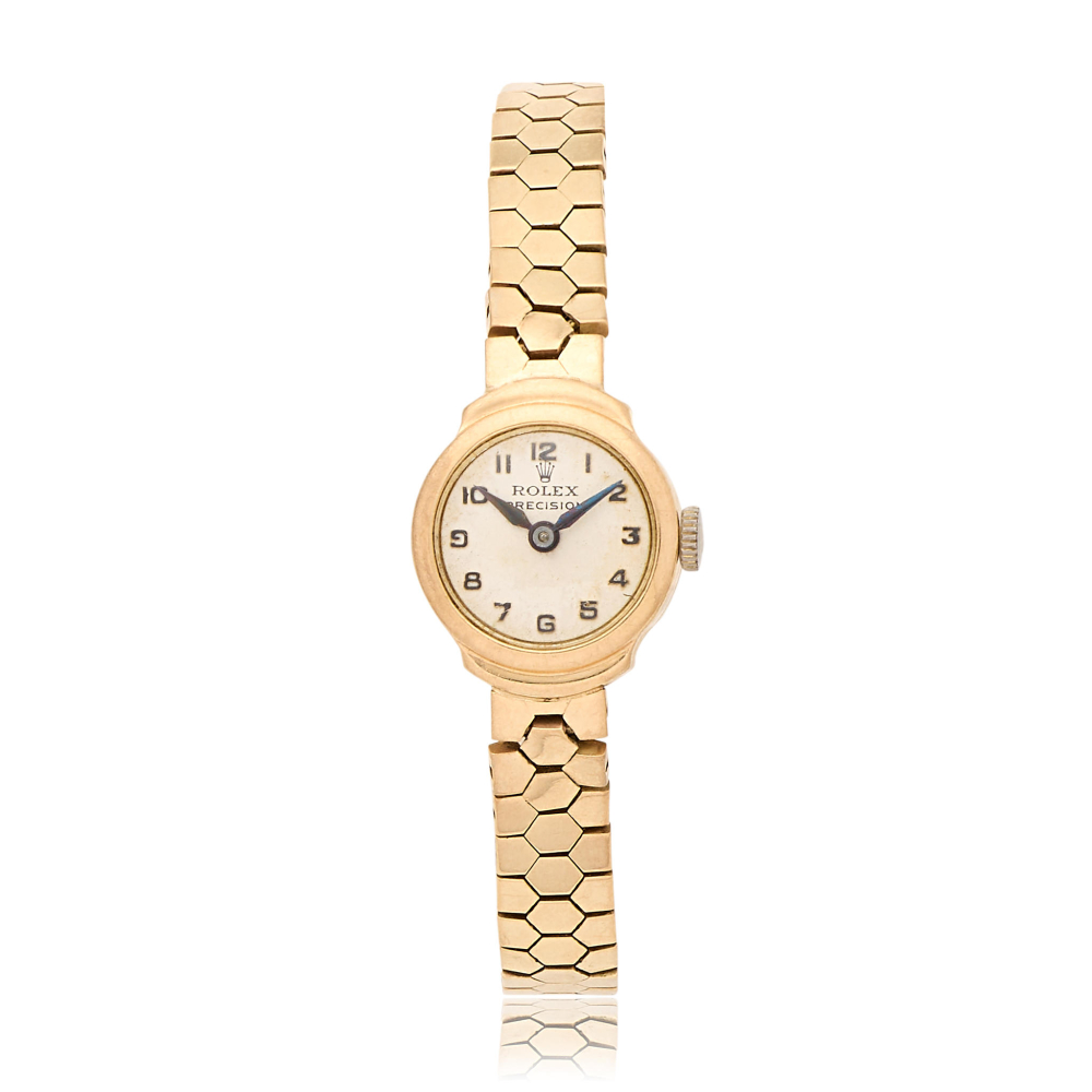 Rolex. A lady's 9K gold manual wind bracelet watch