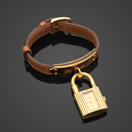 HERMES Paris Swiss Made. Montre Kelly en métal doré plaqué or.