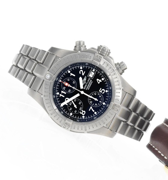 Breitling. A titanium automatic calendar chronograph bracelet watch together with fitted box & papers