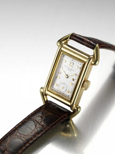 Patek Philippe. A fine and very rare 18ct gold wristwatch with stirrup style case and Extract from Archives