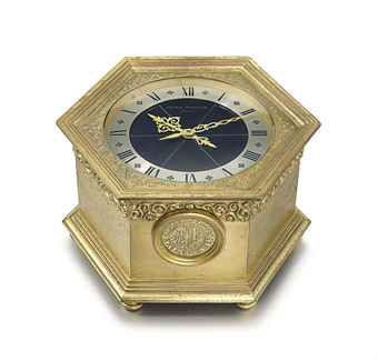 Patek Philippe. A fine and rare, solar powered hexagonal gilt brass table clock