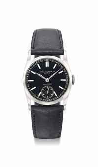 Patek Philippe. A fine and rare stainless steel wristwatch with black dial