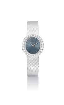 PATEK PHILIPPE. A LADY'S FINE 18K WHITE GOLD AND DIAMOND-SET OVAL BRACELET WATCH