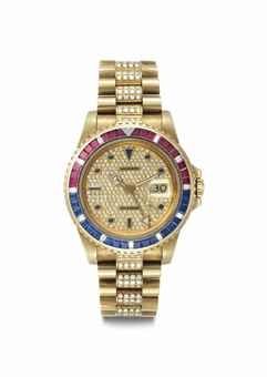 Rolex. An Extremely Rare and Attractive 18k gold, Diamond, Ruby and Sapphire-set Automatic Dual Time Wristwatch with Center Seconds, Date and Bracelet