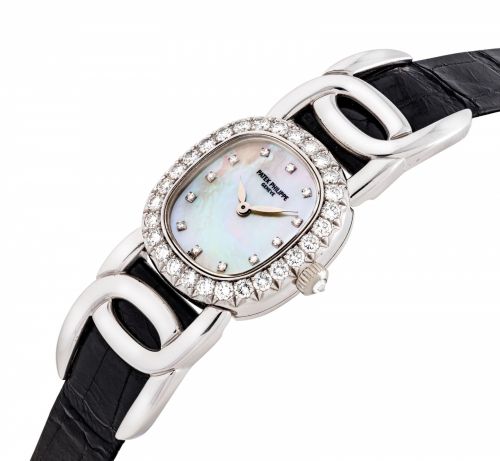 PATEK PHILIPPE. A LADY'S FINE 18K WHITE GOLD AND DIAMOND-SET OVAL-SHAPED WRISTWATCH WITH MOTHER-OF-PEARL DIAL